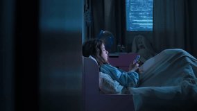 Teen girl lying in bed at night using smartphone, scrolling social media and texting. Not healthy sleep. Insomnia and the harm of the smartphone before going to bed. Dependence on social networks - Powered by Shutterstock - Get 15% off with code: PIKWIZARD15