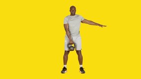 African man doing row exercises with one kettlebell