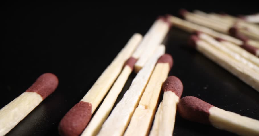 Thin aspen matches with red sulfur heads scattered randomly | Shutterstock HD Video #1104350119