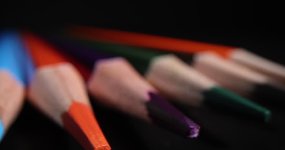 Sharpened multi-colored pencil tips on black background | Shutterstock HD Video #1104350121