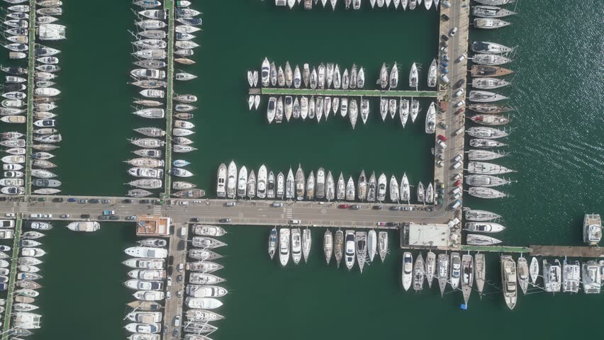 Aerial top view of boats and yachts in marina from above. Yacht parking, A marina lot, Yacht and sailboat is moored at the quay, Aerial view by drone.  | Shutterstock HD Video #1104351801