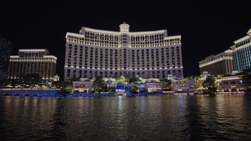 Beautiful view of night attractions of Las Vegas against backdrop of fountains of Bellagio hotel. Las Vegas. USA. Timelapse. | Shutterstock HD Video #1104352755