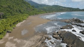 This aerial drone video shows the beach of Dominicalito in Puntarenas, Costa Rica. The pacific coast is very beautiful in this country.