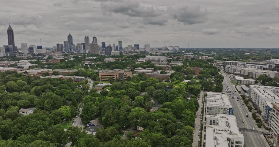 Atlanta Georgia Aerial v854 flyover Georgia Tech campus capturing building blocks, residence hall, sports center and fields with views of downtown cityscape - Shot with Mavic 3 Cine - August 2022
