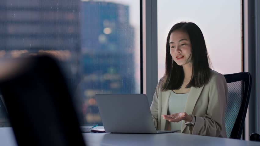 Young happy Asian woman executive team leader or hr manager having remote video conference call meeting communicating by videocall on job interview working on laptop in modern office. Royalty-Free Stock Footage #1104365215