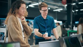 Portrait of a Beautiful Female Customer Seeking Expert Advice from a Retail Home Electronics Specialist for Laptop Purchase. Young Lady Explores Modern Computer Technology Options - Powered by Shutterstock - Get 15% off with code: PIKWIZARD15