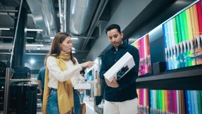 Stylish Multiethnic Couple is Shopping at Retail Electronics Store. Man and Female Found Great Deals on a Modern Smartphone and Tablet Computer Combo. Customers Walking and Discussing Tech Features - Powered by Shutterstock - Get 15% off with code: PIKWIZARD15