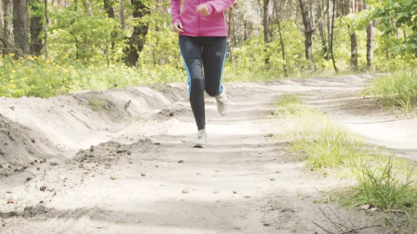 Women Runner tying shoelaces on sneakers.