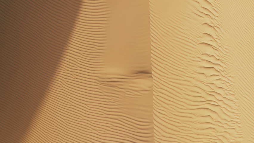 Overhead aerial drone shot of empty desert in California USA. Flying over curve shaped sand dunes with rippling sand texture surface during hot summer weather. Abstract background with copy space 4K Royalty-Free Stock Footage #1104376457