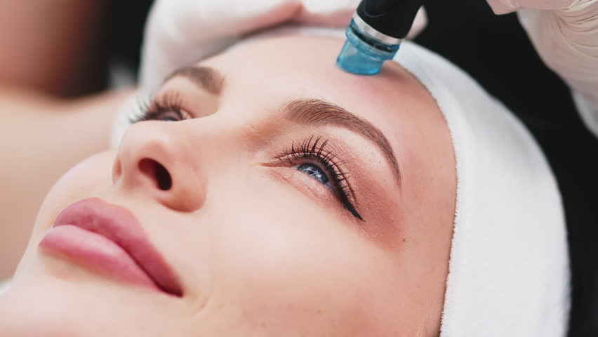 Cosmetologist doing hydrafacial treatment on woman face in beauty clinic
 | Shutterstock HD Video #1104379865
