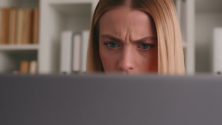 Serious girl frown puzzled stressed Caucasian woman looking at computer monitor problem business failure bad news thinking pensive thoughtful solving web problem businesswoman look at laptop screen Royalty-Free Stock Footage #1104382689