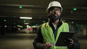 Heavy industry technology engineer Arabian man Indian builder in hard hat electrician architect manufacture worker think pensive ponder problem solution use digital tablet check cyber security system - Powered by Shutterstock - Get 15% off with code: PIKWIZARD15