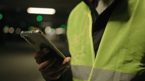Close up unrecognizable man warehouse worker using mobile phone at workplace at factory cropped shot of industrial storehouse manager builder engineer in reflective vest checking email on smartphone - Powered by Shutterstock - Get 15% off with code: PIKWIZARD15