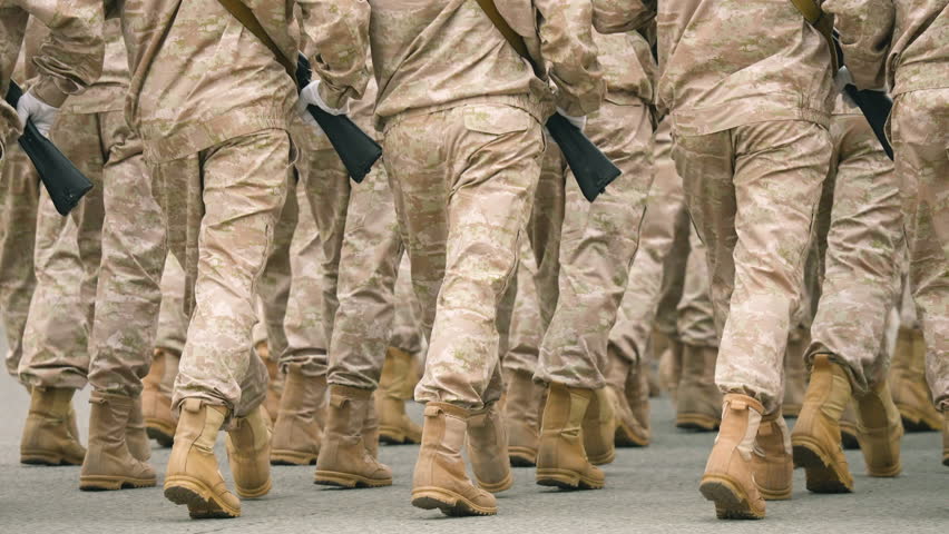 Military boots close up. Lot armed soldier walk slow motion. Male war team. Army platoon step. Many officers march. Men combat troop. Hot spot fight. Nation military forces. Sand desert shoe uniform. Royalty-Free Stock Footage #1104385201