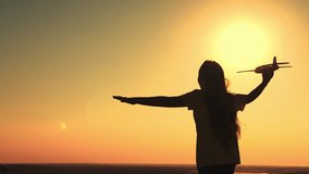 Happy girl runs with an airplane at sunset. hair wind. Game Teen Airplane Pilot. sunny sky. the girl happily runs across the field. pilot plane concept. slow motion. A chidhood dream. - Powered by Shutterstock - Get 15% off with code: PIKWIZARD15