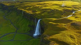 Bird eye view of the Seljalandfoss waterfall in Iceland with beautiful green meadows