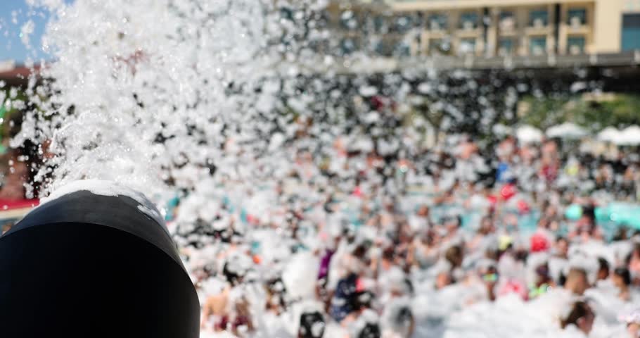 Foam cannon against sky and pool at foam party