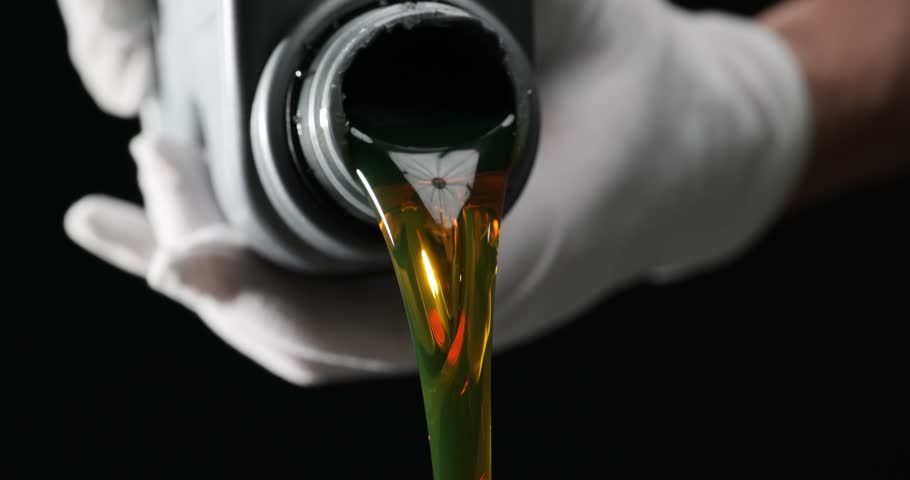 Person pours car motor oil from bottle on black background Royalty-Free Stock Footage #1104391113