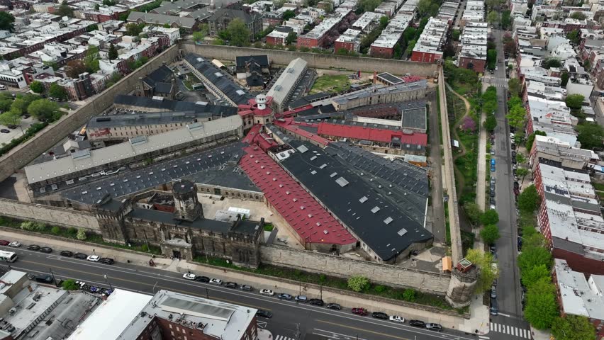 Aerial rotational shot of Eastern State Penitentiary in Philedelphia, PA. Famous historical prison open for educational tours in urban center. Jail, correctional facility theme.