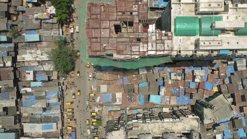 Directly above of skycraper among Dharavi slum density houses, Mumbai. India Royalty-Free Stock Footage #1104401449