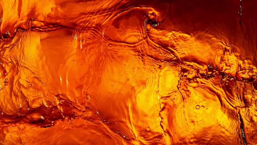 Super Slow Motion of Splashing Whiskey, Close-up. Filmed on High Speed Cinema Camera, 1000 fps. Top View Shot Composition.