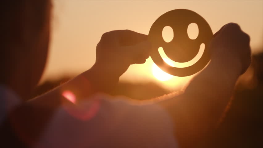 Selective focus of little girl kid holding yellow happy smile face on background amazing warm sunset, good feedback rating and positive customer review, satisfaction survey, mental health assessment | Shutterstock HD Video #1104408735