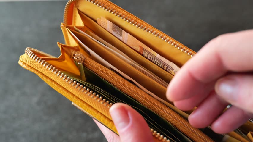 Wallet with money. hand takes out euro bill from yellow leather wallet.Euro bills in a wallet close-up. Slow motion.European Union money. High quality 4k footage Royalty-Free Stock Footage #1104411733