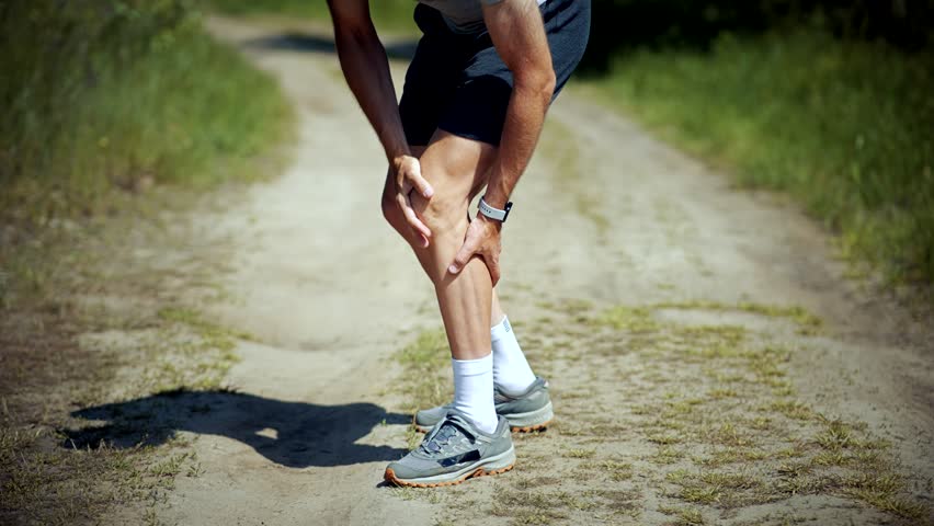 Knee Discomfort Muscle Sprain Strain. Runner Legs Trauma And Muscular Pain. Joint Fatigue Exertion Pain On Knee. Unhappy Sportsman Muscle Sore. Running Overexertion Muscle Cramp Exhaustion Ache Spasm Royalty-Free Stock Footage #1104415319