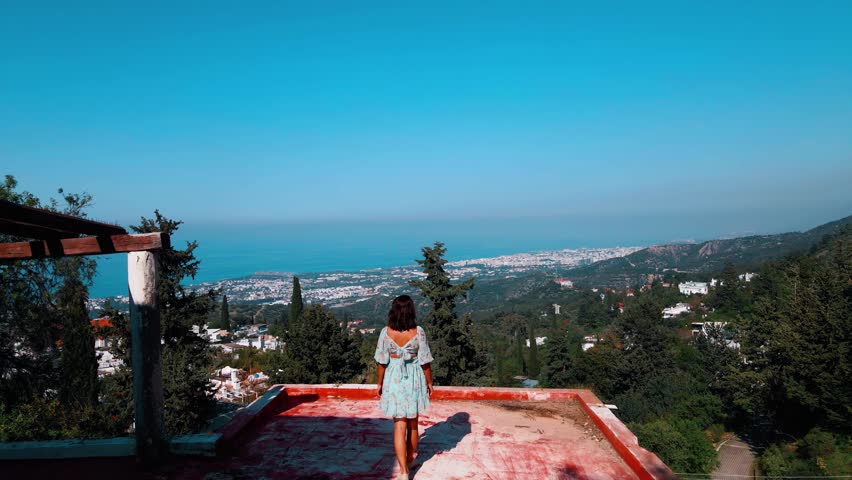 Woman tourist walking at the Karmi village in Kyrenia, North Cyprus on sunny day with clear sky