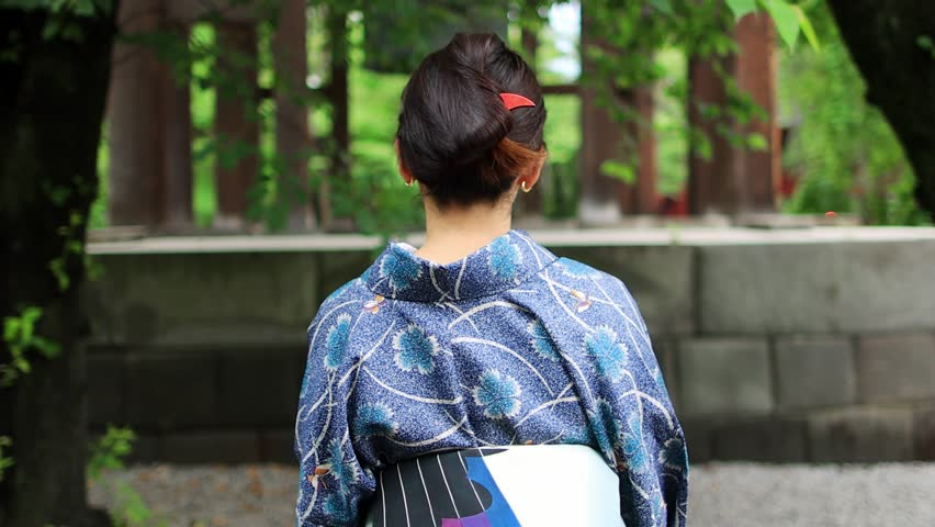 beautiful Japanese woman walking in a traditional kimono near a buddhist shrine in Tokyo, Japanese ethnicity, cultural diversity concept, noble beauty of Japanese women. High quality 4k footage
