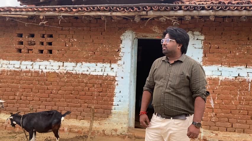 Portrait of an Indian man standing at his house in village. | Shutterstock HD Video #1104425529