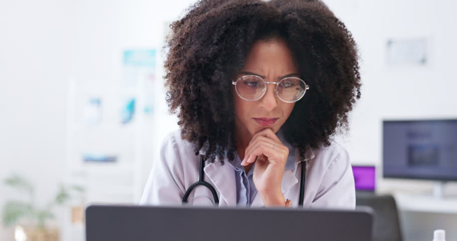 Healthcare, woman and doctor confused, online reading and mistake with review in hospital. Female worker, consultant or medical professional with doubt, confusion and thinking with ideas and a smile | Shutterstock HD Video #1104426219