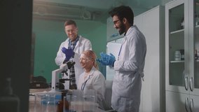 Female scientist showing results of medical experiment to colleagues indoors. Happy lab team clapping and celebrating success. Working day. Night time. Multicultural people concept - Powered by Shutterstock - Get 15% off with code: PIKWIZARD15