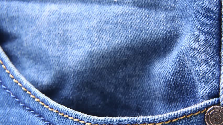 The hamster sticks his muzzle out of his pocket. A hand-held pocket pet hamster climbs out of his pocket. A pet in the pocket of the owner