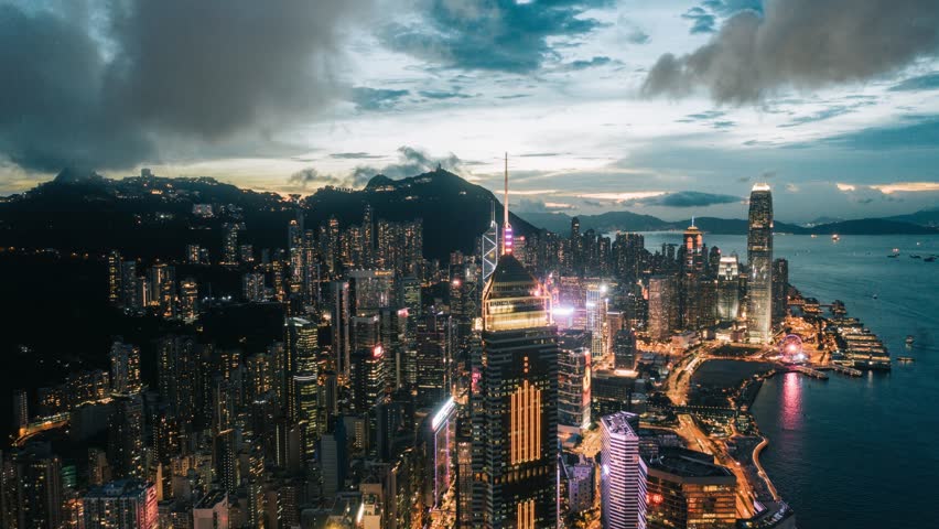 Timelapse Aerial view of Hong Kong skyline at night along Hong Kong Island coastline, China.