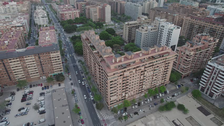 Aerial view of building blocks in the heart of Valencia with the architectural complex of The City of Arts and Science in the background, Valencia, Spain.