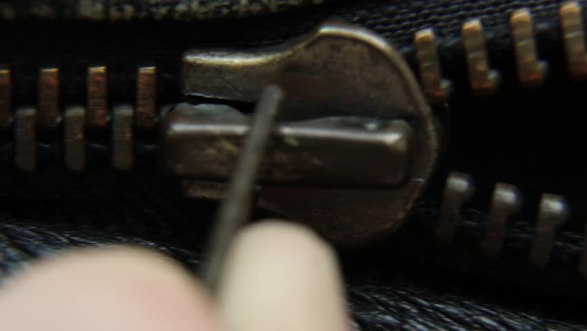 Close-up unzipping vintage zipper metal zipper on a leather jacket. it is unbuttoned. the zipper slowly unzips Royalty-Free Stock Footage #1104446087