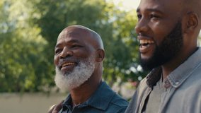 Portrait of loving senior father with adult son outdoors in garden at home or countryside smiling and laughing together - shot in slow motion - Powered by Shutterstock - Get 15% off with code: PIKWIZARD15