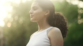 Pretty young indian woman looking ahead and exhaling fresh air taking deep breath and reducing stress at park Confident female do workout cardio for strong body outdoors - Powered by Shutterstock - Get 15% off with code: PIKWIZARD15
