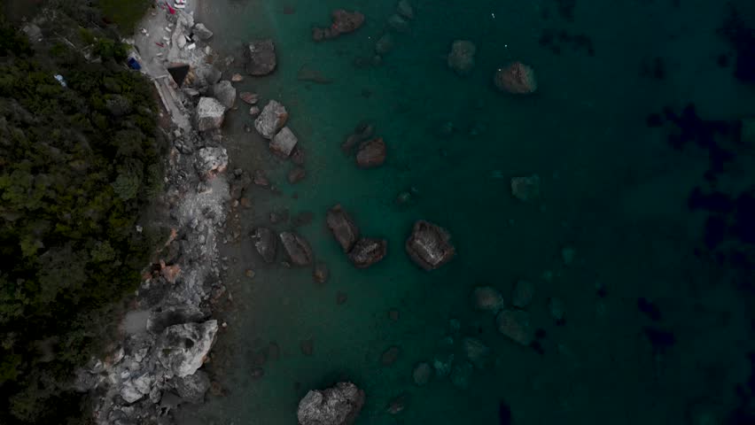 Pebbled Shore Of Jaz Beach Overlooking The Adriatic Sea And Balkan Mountains In Montenegro. Aerial Tilt-up