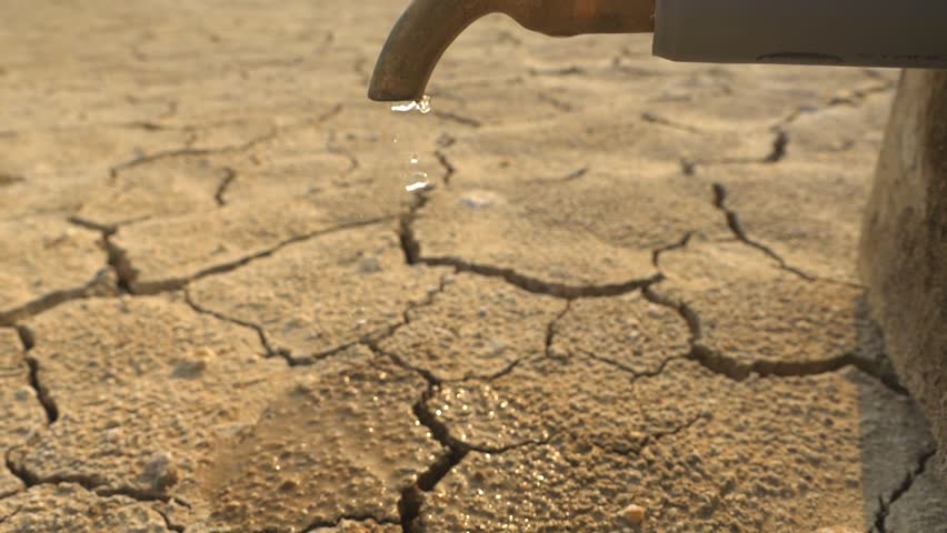 tap of water in the desert, drought landscape, dry soil. lack of fresh drinking water. world water day, clean water sanitation. global environment crisis. faucet close up 