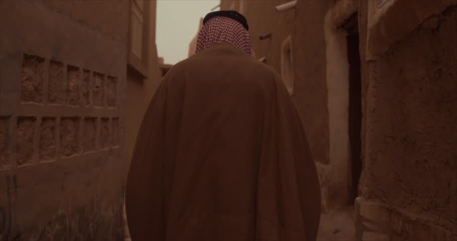 A Saudi man walking among the lanes of the old town (mud houses) Royalty-Free Stock Footage #1104464035