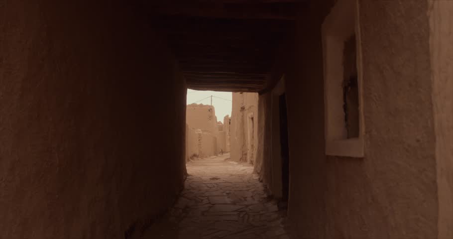 A Saudi man walking among the lanes of the old town (mud houses) Royalty-Free Stock Footage #1104464039