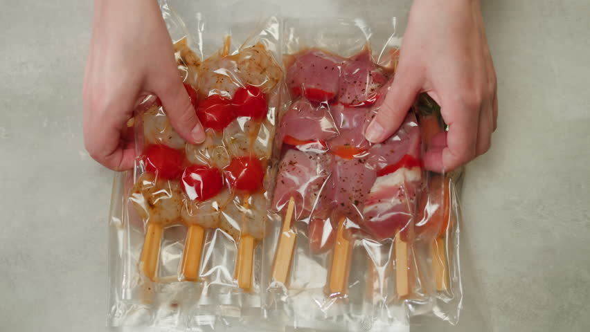 Beef, chicken and salmon tapas skewer in vacuum plastic bag ready for sous vide cooking or grill, supermarket ready to eat food. | Shutterstock HD Video #1104465835