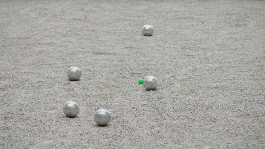 Petanque balls boules bowls on sand gravel court background in Barcelona, spain, traditional french game of petanque on the ground.  Royalty-Free Stock Footage #1104466709