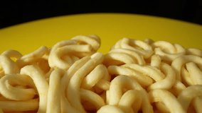 Showcasing the distinctive texture that instant noodles. The surface of the noodles may have a glossy sheen, resulting from the pre-cooking process that involves frying or drying. Macro probe lens.
