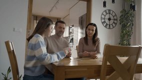 Zoom in of caucasian family of parents and teenage girl playing cards by the table. Shot with RED helium camera in 8K.   - Powered by Shutterstock - Get 15% off with code: PIKWIZARD15