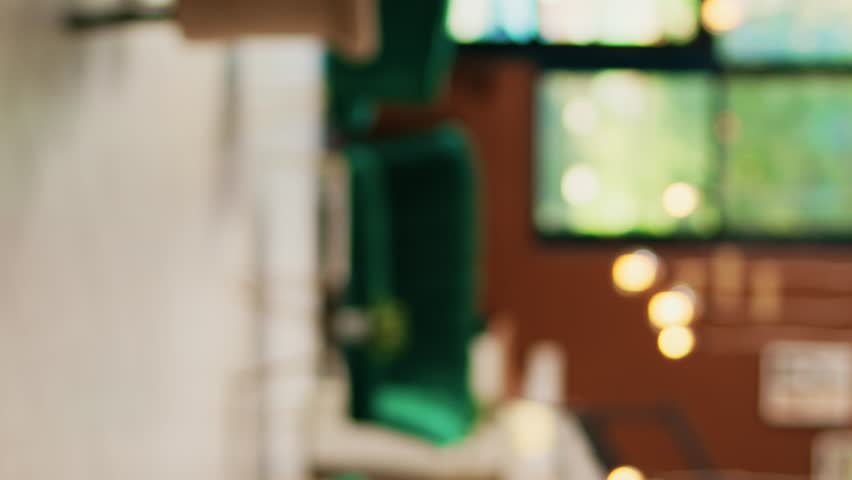 Vertical video Empty hotel front desk and entrance with lounge area, stylish luxury furniture and interior deisgn. Modern classy exotic seaside resort with reception counter, elegant decor and plants.