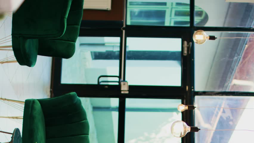 Vertical video Empty hotel reception and lobby with lounge area, modern classy furniture and interior deisgn. Stylish luxurious tropical resort with front desk counter, elegant decor and plants.