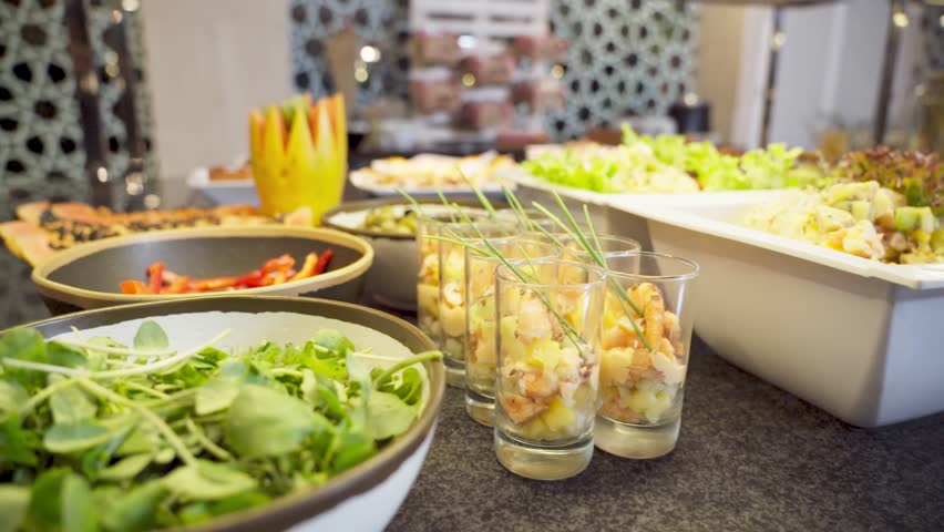 Dessert buffet with tropical fruits and a variety of food vegetables salads for restaurant customers in the hotel. Close up | Shutterstock HD Video #1104480133